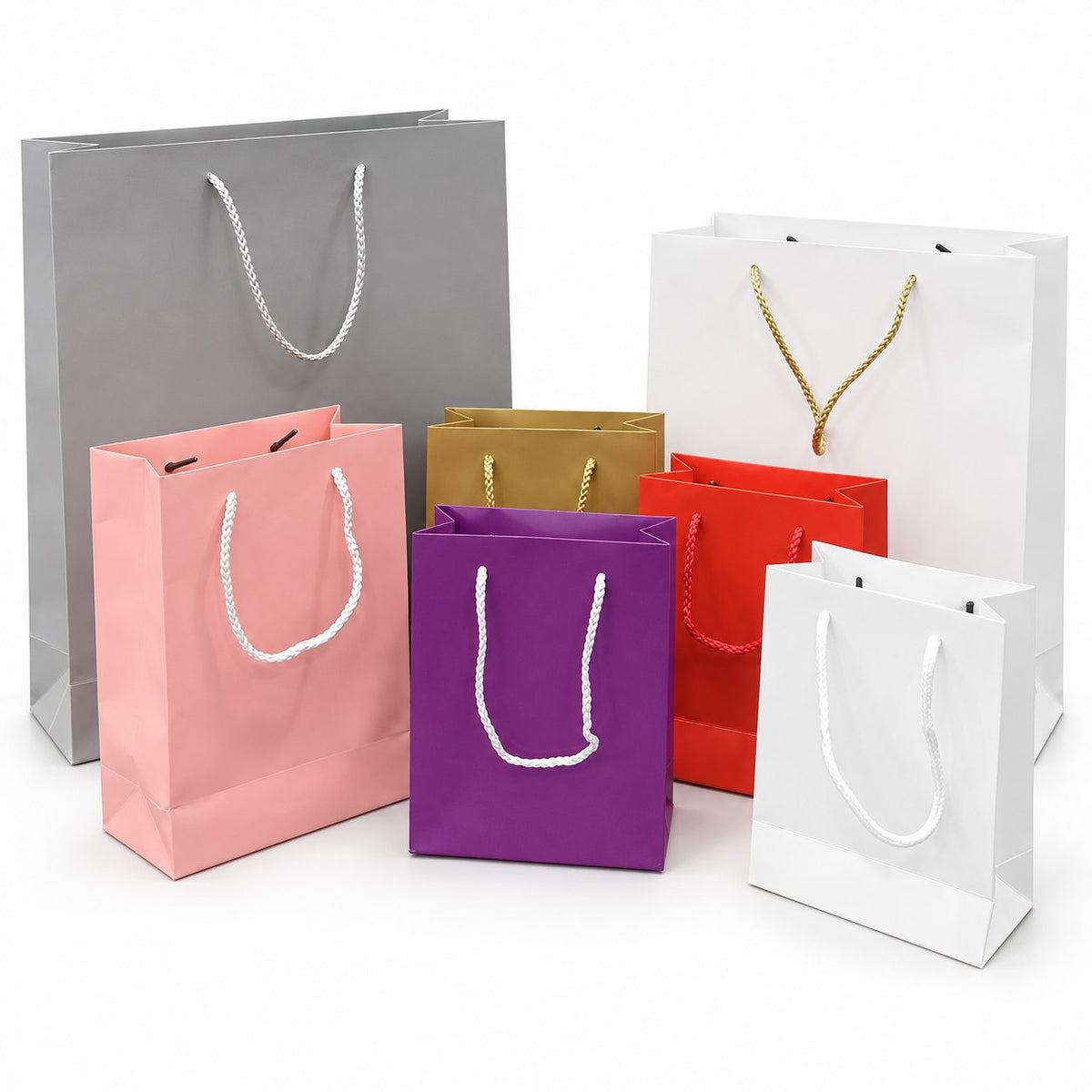 Coloured cardboard shopping bags on a white background